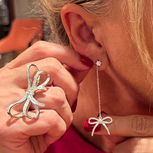 Wear this Ribbon Ring for a touch of class. It's a great choice for everyday wear, but it's also perfect for special occasions. The ribbon design is a stylish way to bring an elegant touch to any outfit. The silver plating helps prevent tarnishing and the crystals adds a touch of sparkle.